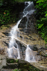 Obraz premium A beautiful waterfall inside tropical rainforest. Long exposure and slow shutter