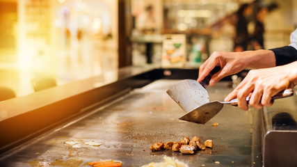 Hand of man take cooking of meat with vegetable grill.