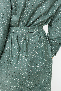 Details of women's clothing. Detail dress on a model on a white background