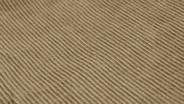 Slow pan on velvet fabric pants tufted parallel cords 4K 2160p 30fps UltraHD footage - Panning on fibers of brown cotton corduroy 3840X2160 UHD video 