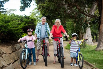 multi-generation family standing with bicycle