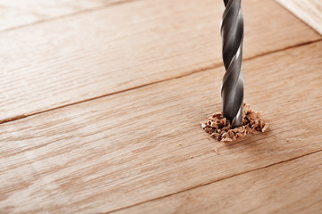 metal drill bit make holes in wooden oaks plank