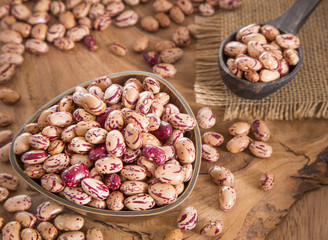 Pinto beans on wood bowl