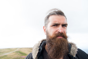 bearded handsome serious man on mountain top