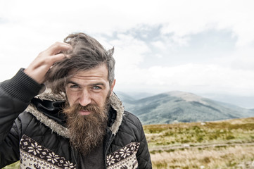 bearded handsome serious man on mountain top