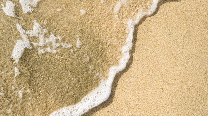 Tranquil waves washing over the beach sand