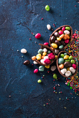 Delicious chocolate easter eggs ,bunny and sweets on dark blue background
