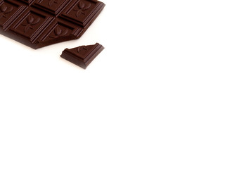 Broken chocolate bar left position isolated on white table. Horizontal composition. Top view