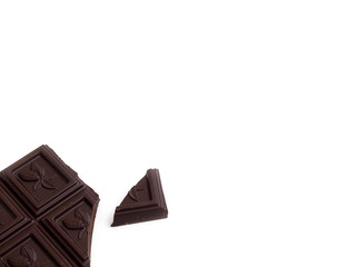 Broken chocolate bar left position isolated on white table. Horizontal composition. Top view
