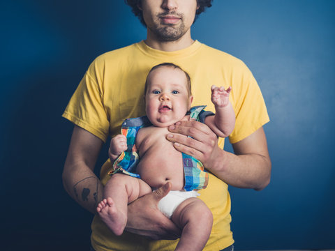 Young father with happy baby