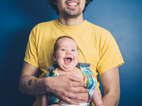 Young father with happy baby