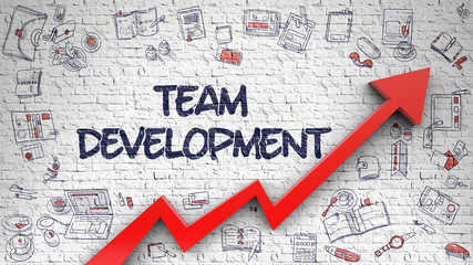 Team Development Drawn on White Brick Wall. 