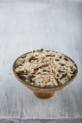 A mix of 4 types of rice. Weathered wood background. 