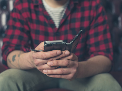 Young man on sofa using smartphone