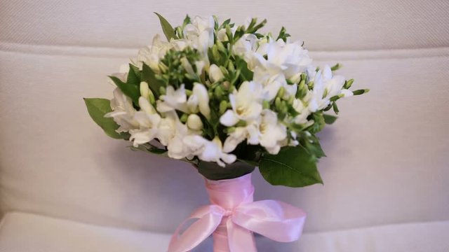 Wedding bouquet on white sofa shot
