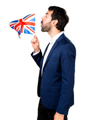 Handsome man holding an UK flag