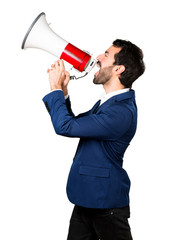 Handsome man shouting by megaphone