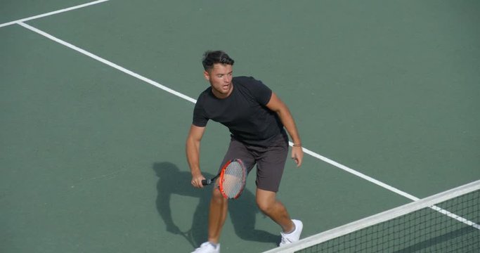 Tennis Player at net volleys and celebrates Win.
