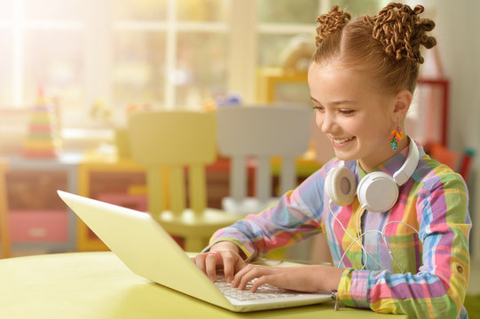 cute little girl using laptop