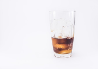 one of thirds soft drink is cool with two of thirds ice cubes in glass on white back ground