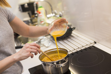 Young woman prepares food in a modern kitchen.