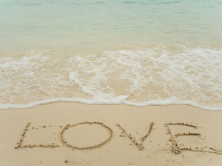 Writing love on beach