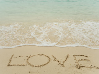 Writing love on beach