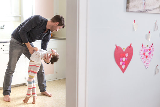 Father tickling young daughter 