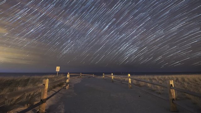 Star Trails passing with a beach path foreground