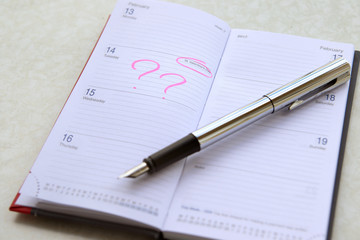  notepad with fountain pen. Man plans 14 February