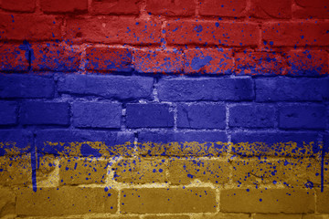 painted national flag of armenia on a brick wall