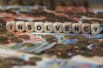 insolvency - cube with letters, money sector terms - sign with wooden cubes