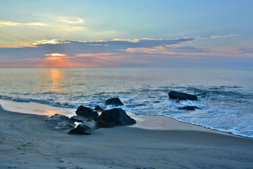 Scenic Summer Sunrise Over Rock Jetty at the Shore