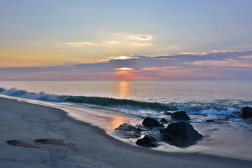 Pastel Colored Sunrise at the Seashore Over Rock Jetty