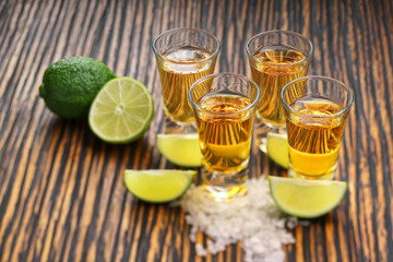 Glasses gold tequila with green lime  o