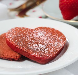Heart shaped red velvet pancakes / Valentine breakfast concept, selective focus
