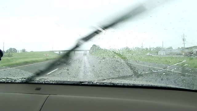 Raindrops on a windshield  windshield wipers going