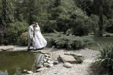 Bride and groom walking in the park