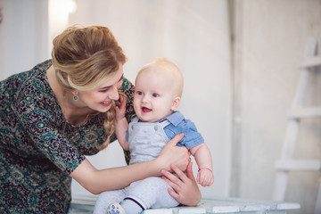 Happy loving family. Young mother holds baby son in her arms.