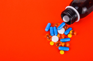 Various pills and bottle on bright background