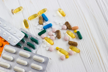 many colored medicine pills on white background