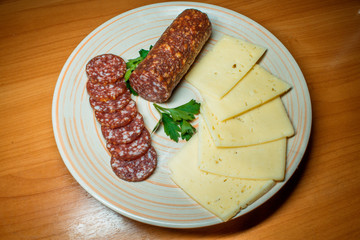 Fresh salami with cheddar and Swiss cheese and whole wheat crackers