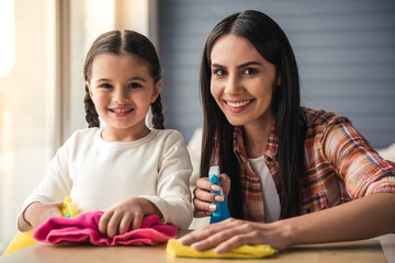 Mom and daughter cleaning house