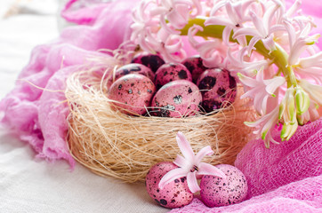 Fototapeta na wymiar Easter background with pink hyacinth and decorative eggs.