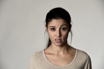 beautiful arrogant and moody spanish woman showing negative feeling and contempt facial expression