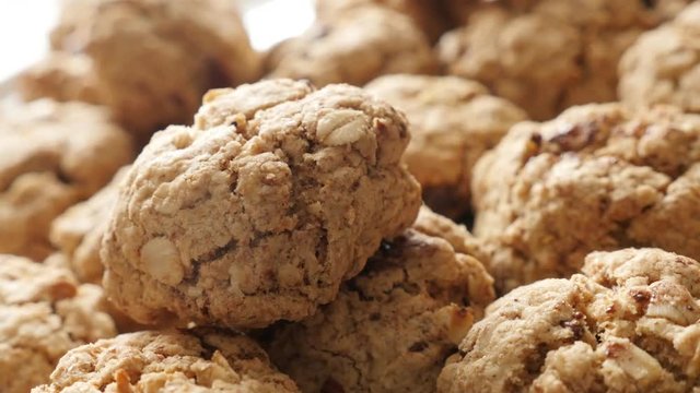 Slow pan on tasty homemade biscuits with oatmeal served on plate 4K 2160p 30fps UHD footage - Chocolate chip cookies on pile close-up shallow DOF 3840X2160 UltraHD panning video