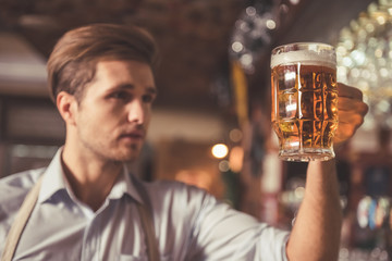Handsome bartender with beer