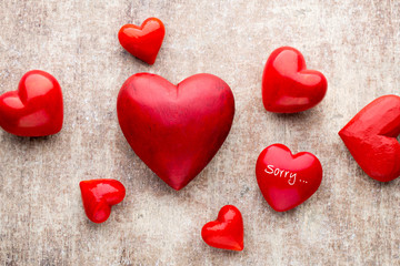 Red heart on the wooden background.
