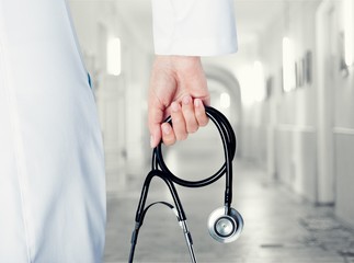 Holding a stethoscope.