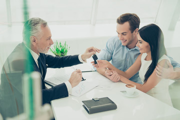 Real estate agent working with couple of customers and giving th
